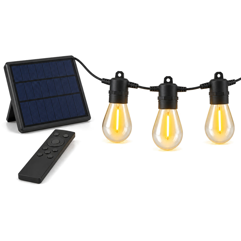 Ljusslinga med glödlampor, separat solpanel och fjärrkontroll mot vit bakgrund
