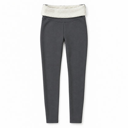 Gråa leggings utbredda med nedvikt midja som visar krämvitt fleecefoder på vit bakgrund