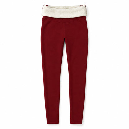Röda leggings utbredda med nedvikt midja som visar krämvitt fleecefoder på vit bakgrund
