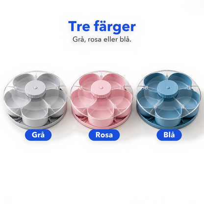 Snacksbrickan i tre färger: grå, rosa och blå, på vit bakgrund