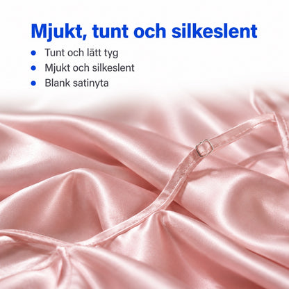 Makrobild av mjukt blekrosa satin med tunt axelband och justerbart metallspänne, rubrik Mjukt, tunt och silkeslent